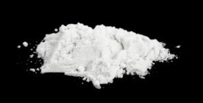 Officers following a man in a stolen vehicle case uncovered cocaine, a firearm and drug paraphernalia when they followed him into a home. (Depositphotos.com)
