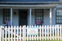A sign for a property management company can be seen on the fence for a vaction rental on Tybee Island.